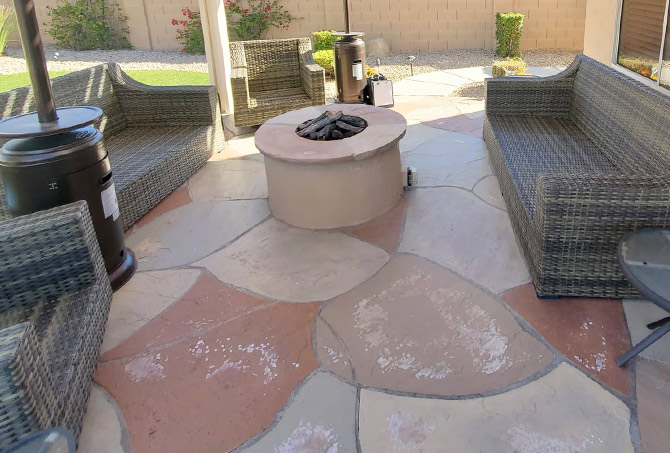 This is a flagstone sitting area with a fire feature that has needs professional attention.