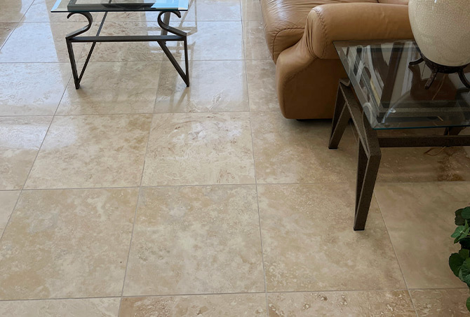 In this BEFORE image, the travertine floor has reflection under the coffee table but the walking areas look dull.