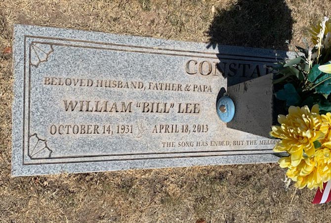 A granite headstone has stains.