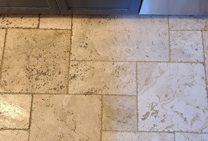 The right side of the travertine floor is cleaned and the left side is not yet cleaned.